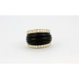 A yellow metal (tested high carat gold) ring set with carved onyx and diamonds, (M).