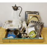 A tray of silver plate and photo frames.