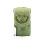 An unusual Chinese carved pale celadon russet jade cylinder decorated with two mask like faces, H.