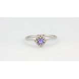 A 9ct white gold tanzanite and diamond set cluster ring, (P.5).