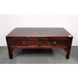 An early 20th century Chinese elm wood two drawer table, 101cm x 52cm x 42cm.