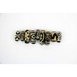 A group of nine Tibetan Dzi beads, longest 4.2cm.