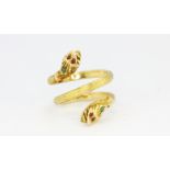 A yellow metal (tested high carat gold) double headed snake shaped ring set with rubies and