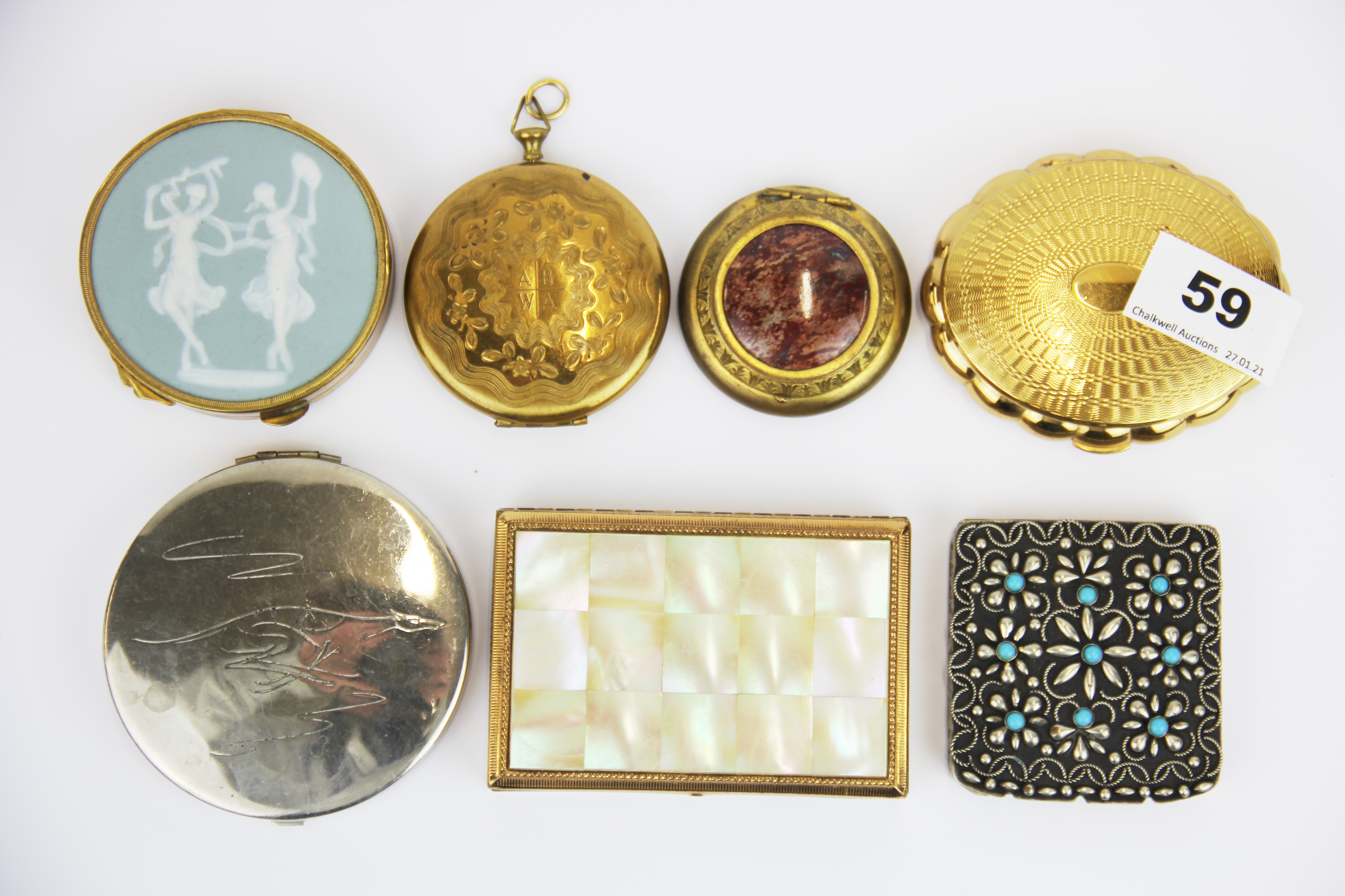 A group of seven vintage compacts.