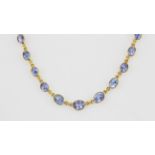 A 14ct yellow gold (stamped 585) necklace set with oval cut Ceylon sapphires, L. 40cm.