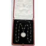 An Art Deco white metal (tested platinum) locket necklace, set with rose and old cut diamonds and