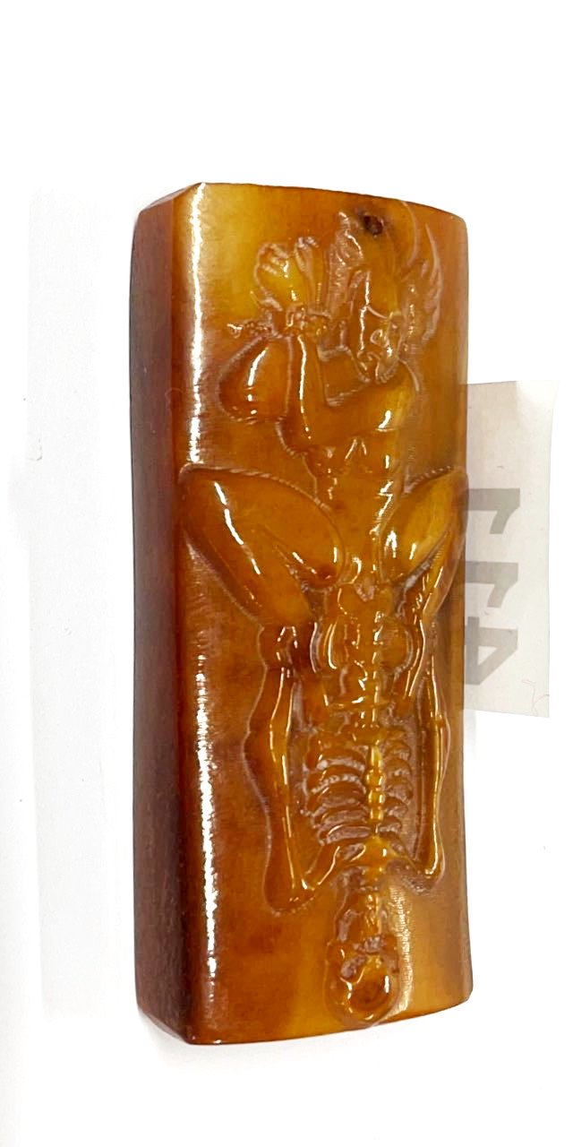 An unusual Tibetan carved yak bone erotic amulet, L. 9cm.