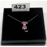 A silver ruby and diamond set cat pendant, L. 2.4cm, on a silver chain.
