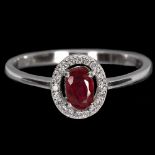 A 925 silver oval cut ruby and white stone set halo ring, (N.5).