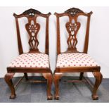 A pair of early 19th century carved walnut side chairs.