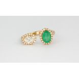 An 18ct rose gold adjustable ring set with an oval cut diamond and emerald, surrounded by