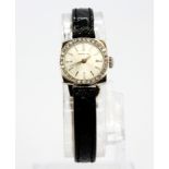 A boxed lady's Longines white metal (tested 18ct gold) wrist watch with diamond set bezel on a