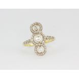 A 14ct (stamped 585) yellow gold triple halo ring set with three brilliant cut diamonds surrounded