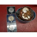 A box of mixed coins and medals.