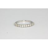 An 18ct white gold (750) diamond set half eternity ring, approx. 0.50ct, (N).