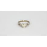 An 18ct white gold solitaire ring set with an apporx. 1ct brilliant cut diamonds and diamond set
