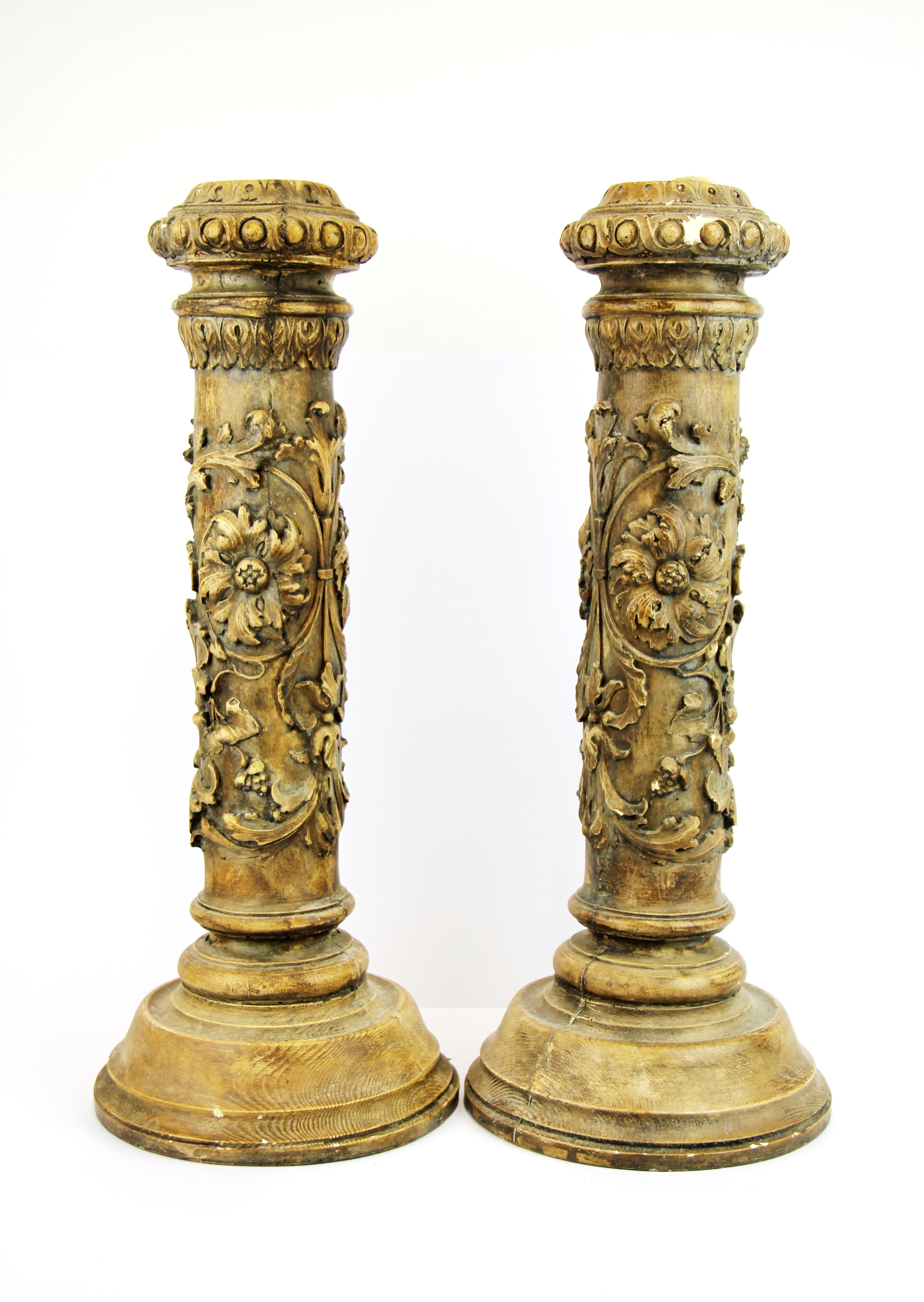A pair of large cast stoneware (mimicking carved wood) candlesticks, H. 52cm.