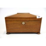 An early 19th Century mahogany tea box with hinged caddies and original mixing bowl with a mother of