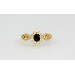 An 18ct yellow gold sapphire and white stone set cluster ring, approx. 3.3gr, (P).