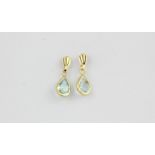 A pair of 9ct yellow gold drop earrings set with pear cut blue topaz, L. 1.9cm.