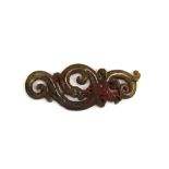 A Chinese carved archaic form jade amulet of a dragon with pigment and other residue, L. 9.5cm.