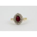 An 18ct yellow gold ruby and diamond set cluster ring, (N.5).