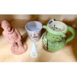 A pottery puzzle jug with a pottery figural match striker, a Royal Worcester owl candle snuffer