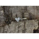 An 18ct white gold (stamped 750) heart shaped ring set with three brilliant cut diamonds, approx..