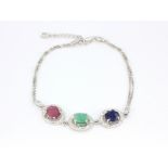 A 925 silver bracelet set with oval cut ruby, sapphire and emerald, L. 22cm.