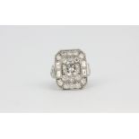 A large 950 platinum ring set with a 1.5ct brilliant cut diamond surrounded by brilliant cut