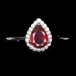 A 925 silver cluster ring set with a pear cut ruby surrounded by white stones, (O).