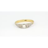 An 18ct yellow and white gold brilliant cut diamond set solitaire ring, (S).