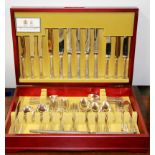 A boxed silver plated cutlery set with additional carvers.