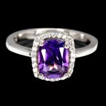 A 925 silver ring set with a scissor cut amethyst and white stones, (O.5).