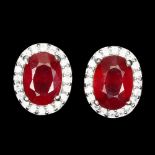 A pair of 925 silver stud earrings set with oval cut rubies surrounded by white stones, L. 0.9cm.