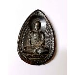 A Tibetan carved yak horn devotional Buddhist amulet, H. 6.5cm.