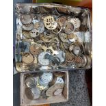 A tin of watch cases and movements.