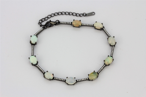 A 925 silver bracelet set with cabochon cut opals and white stones, L. 17cm.