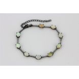 A 925 silver bracelet set with cabochon cut opals and white stones, L. 17cm.