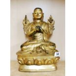 A Tibetan gilt bronze figure of a seated Buddhist Deity, H. 33cm.