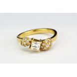 An 18ct yellow gold (stamped 18ct) ring set with a baguette cut diamond and brilliant cut diamond