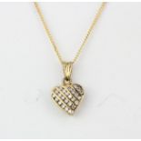 A 9ct yellow gold diamond set heart shaped pendant and chain, L. 2cm.