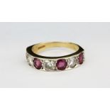 A 9ct yellow gold ring set with rubies and brilliant cut diamonds, (Q).