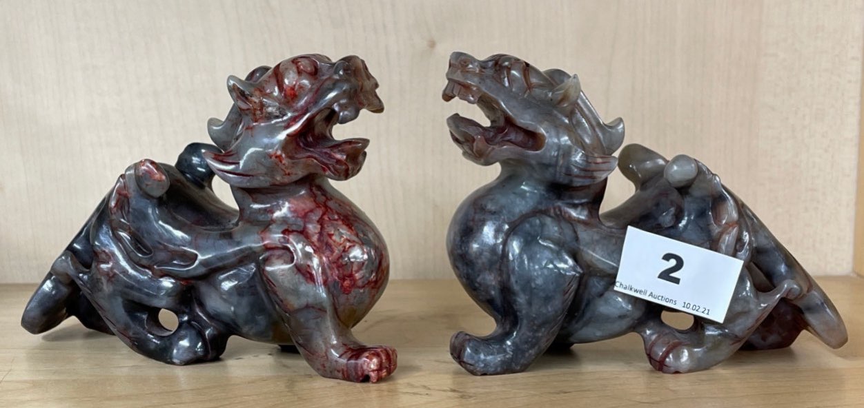 A pair of Chinese carved soapstone dragon figures, H. 10cm. L. 15cm.