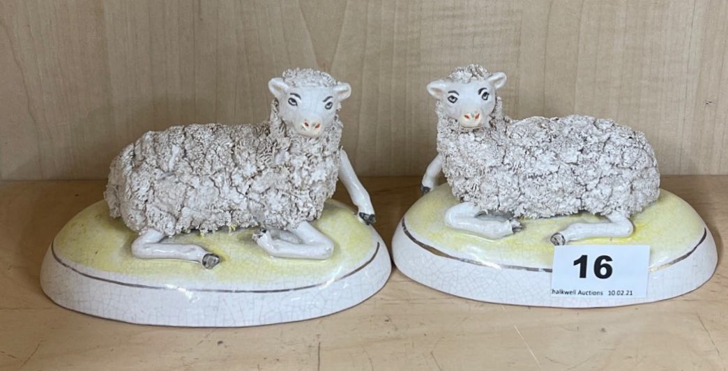 A pair of Staffordshire figures of sheep, W. 13cm. H. 9cm.