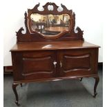 A carved mahogany dressing table, W. 121cm. H. 140cm.