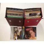 A collection of mixed records in cases.
