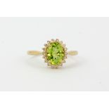 A 9ct yellow gold peridot and diamond set cluster ring, (M).