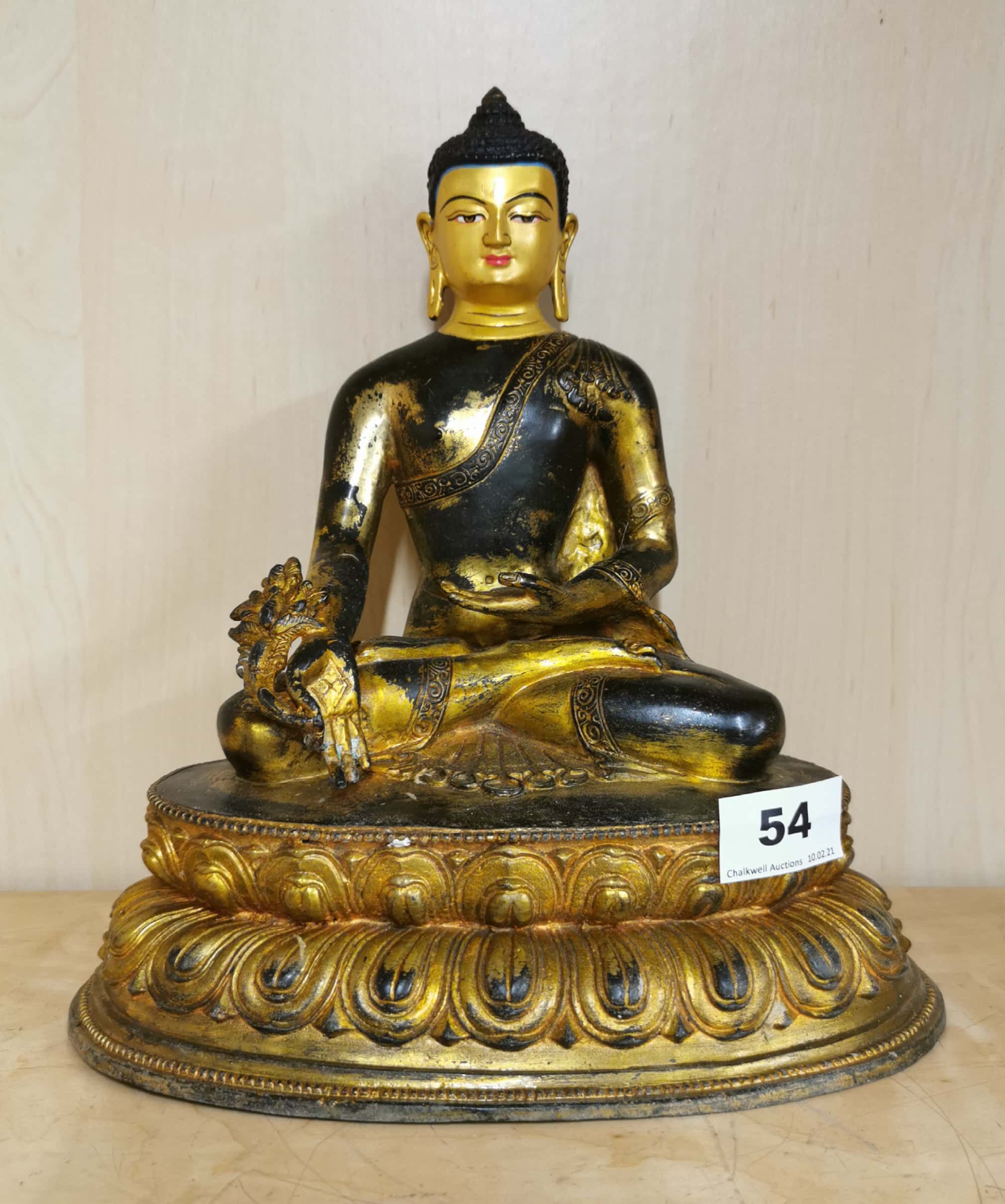 A Tibetan temple quality gilt and hand painted bronze figure of a seated Buddha, H. 27cm.
