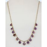 A 9ct yellow gold (stamped 9ct) necklace set with fancy hexagonal cut amethysts, L. 42cm.